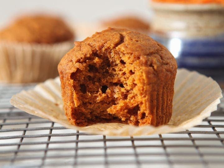 Close up of a vegan pumpkin muffin with a bite taken out of it