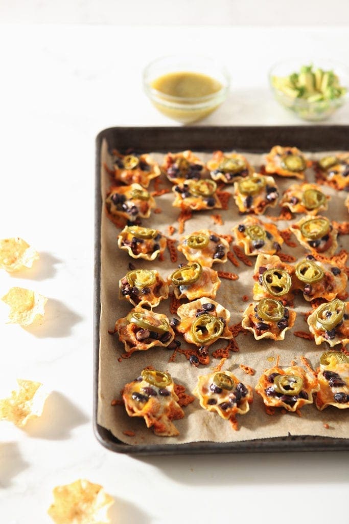 Taco cups are shown on a baking sheet after baking, before toppings are added.