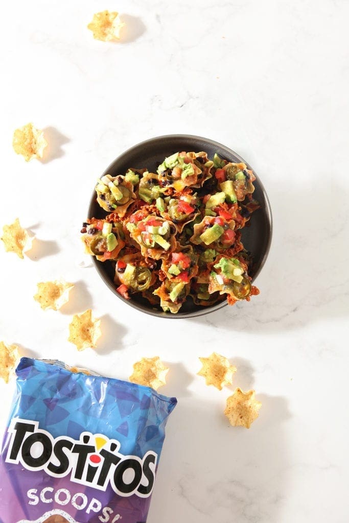 Vegetarian Taco Cups are shown from above in a bowl with a bag of tortilla chips