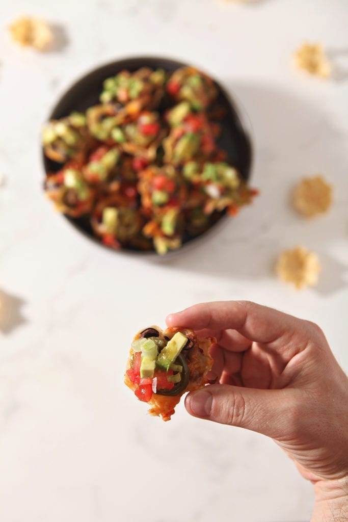 A man holds an individual taco cup, from above