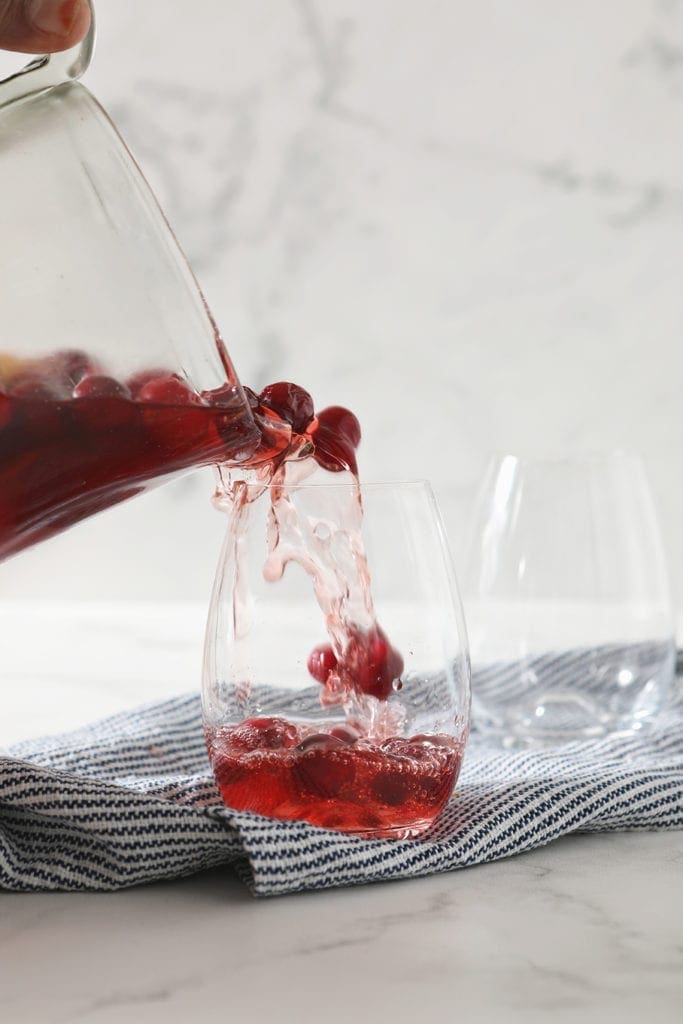 Cranberry Sangria is poured into a glass