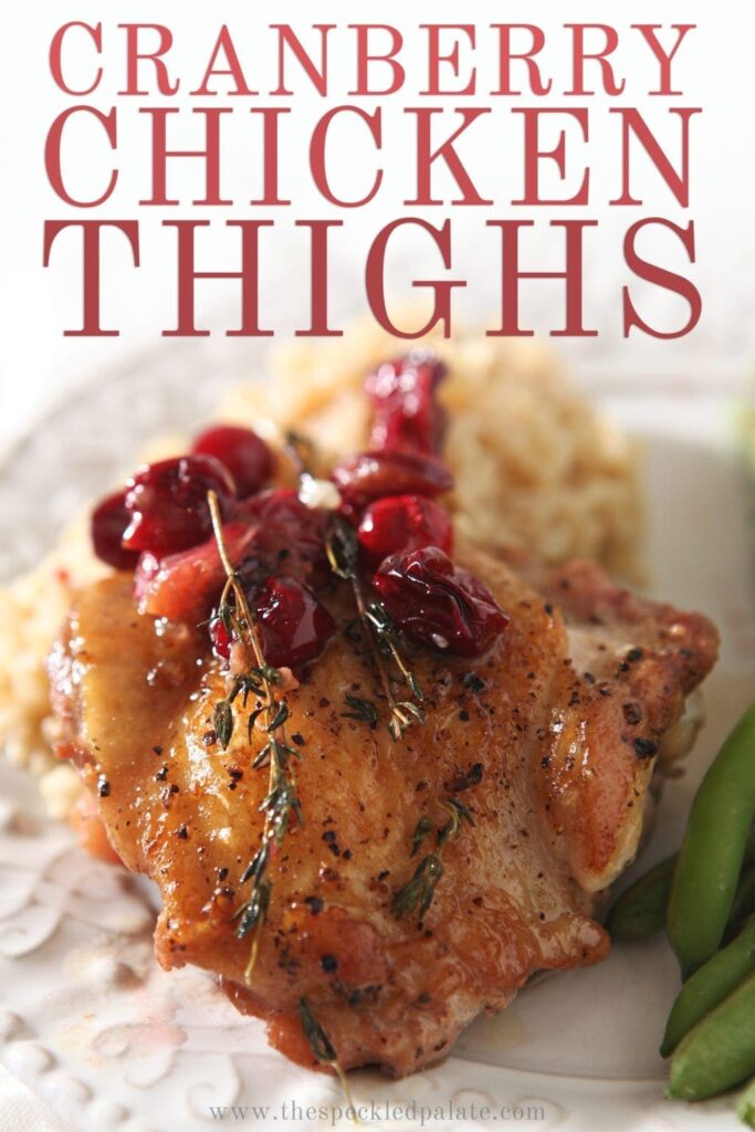 Close up of a Cranberry Chicken Thigh on a plate, with Pinterest text