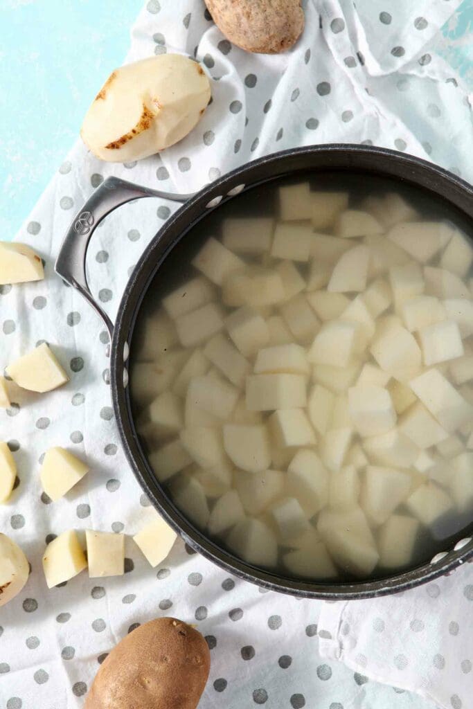 Diced potatoes in water in a stock pot before cooking