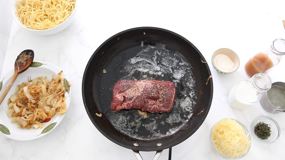 Searing a steak in a skillet, from above