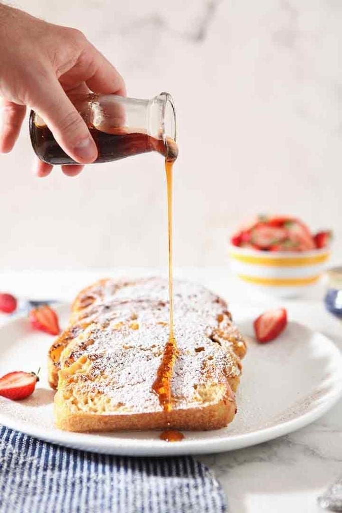 Maple syrup is drizzled on top of the French toast