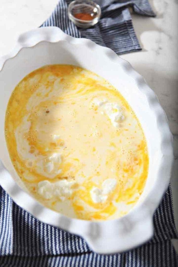 Yogurt is mixed into the egg mixture, shown in a baking dish