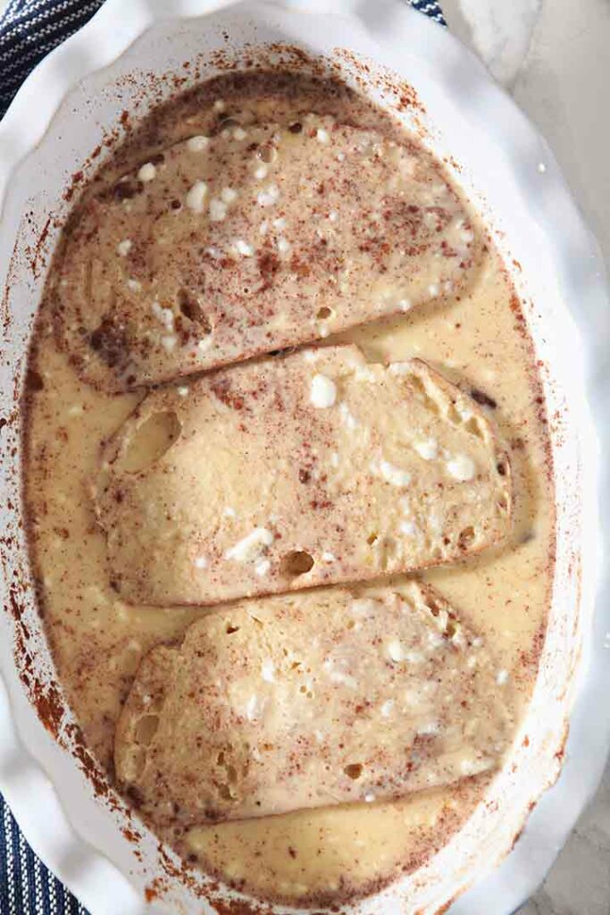 Close up of sliced bread soaks in the egg-milk-yogurt mixture