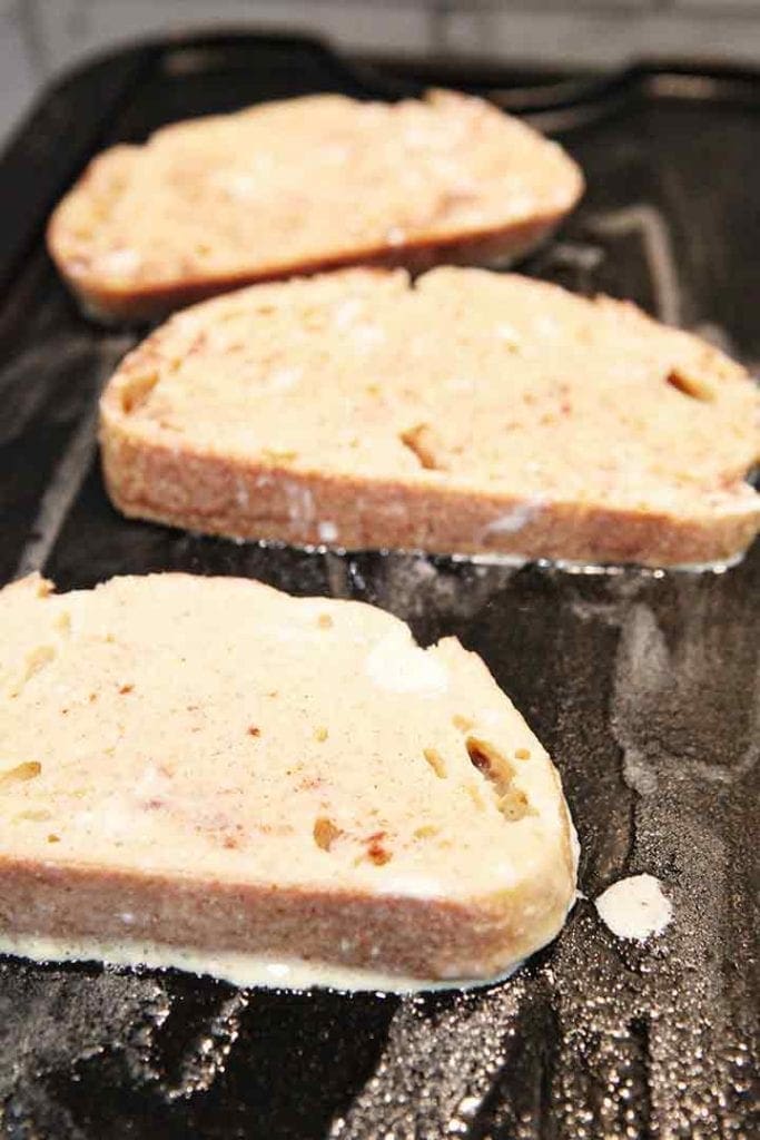 French toast cooks on a griddle on the stovetop