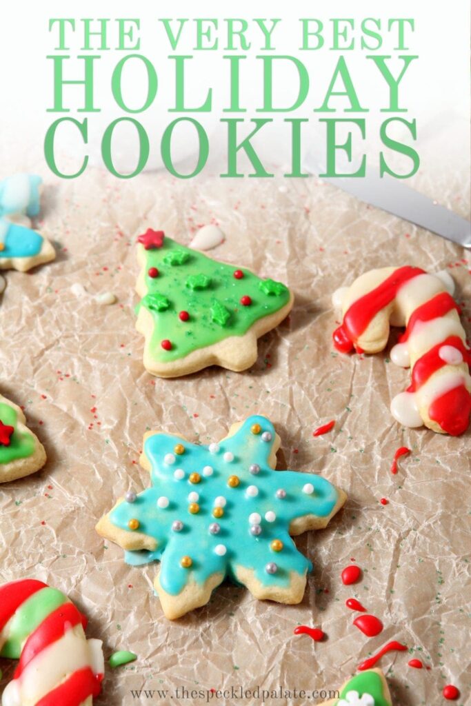 Decorated and colorful sugar cookies on a brown paper, with Pinterest text