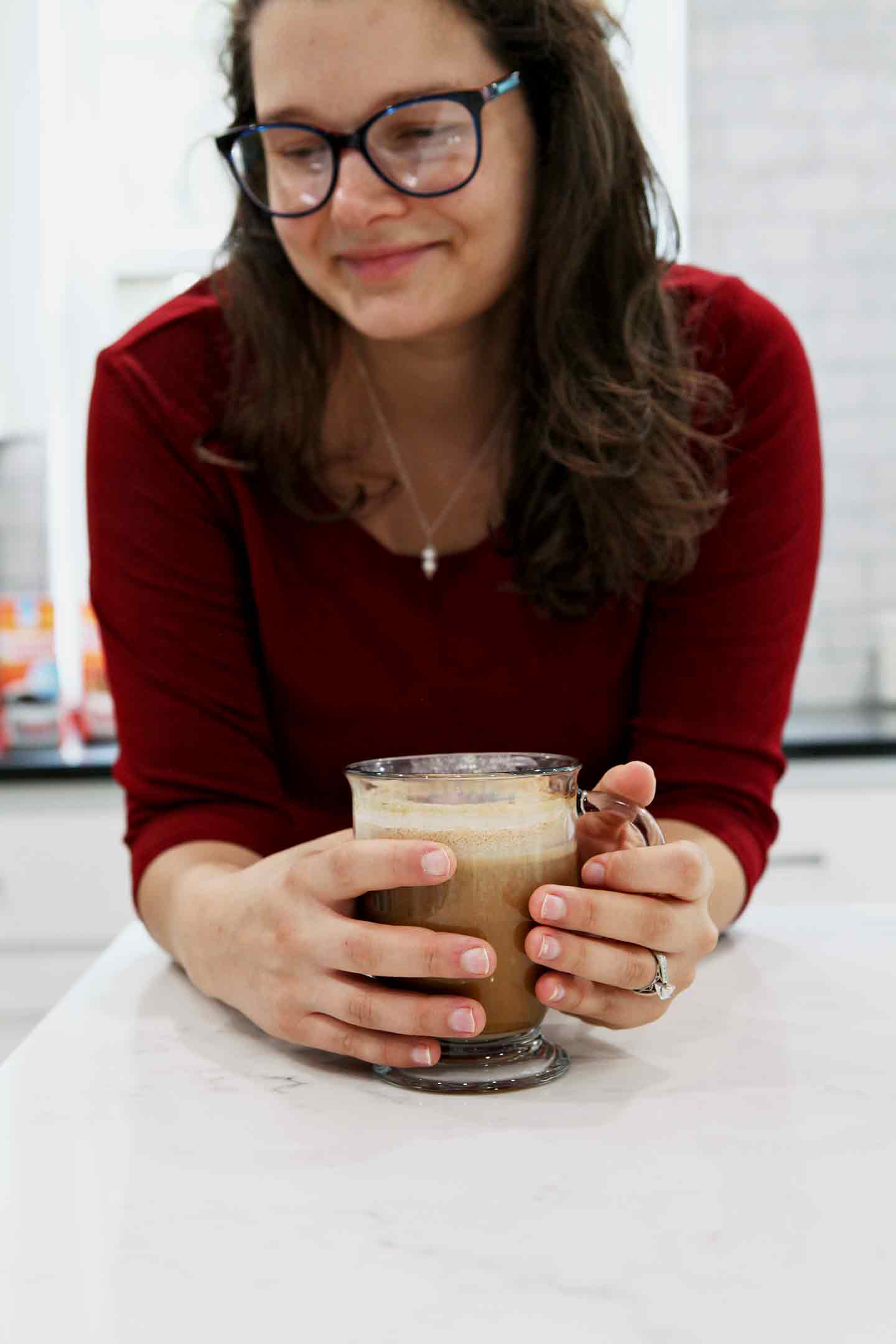 A woman holds a mug of coffee