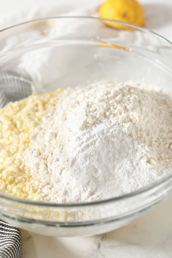 Dry ingredients sit on top of wet ingredients in a clear bowl, before blending