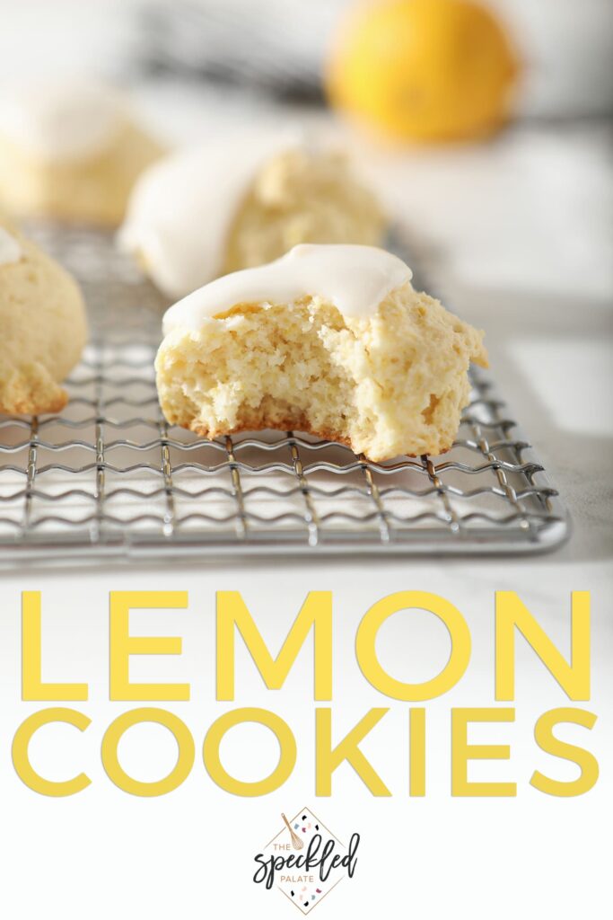 Close up of a bitten into Lemon Drop Cookie on a metal tray, with Pinterest text