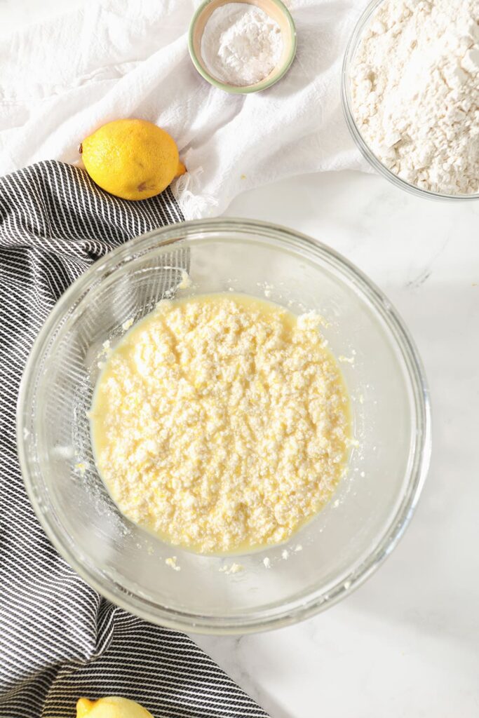 Lemon cookie dough wet ingredients, mixed, are shown in a bowl form above