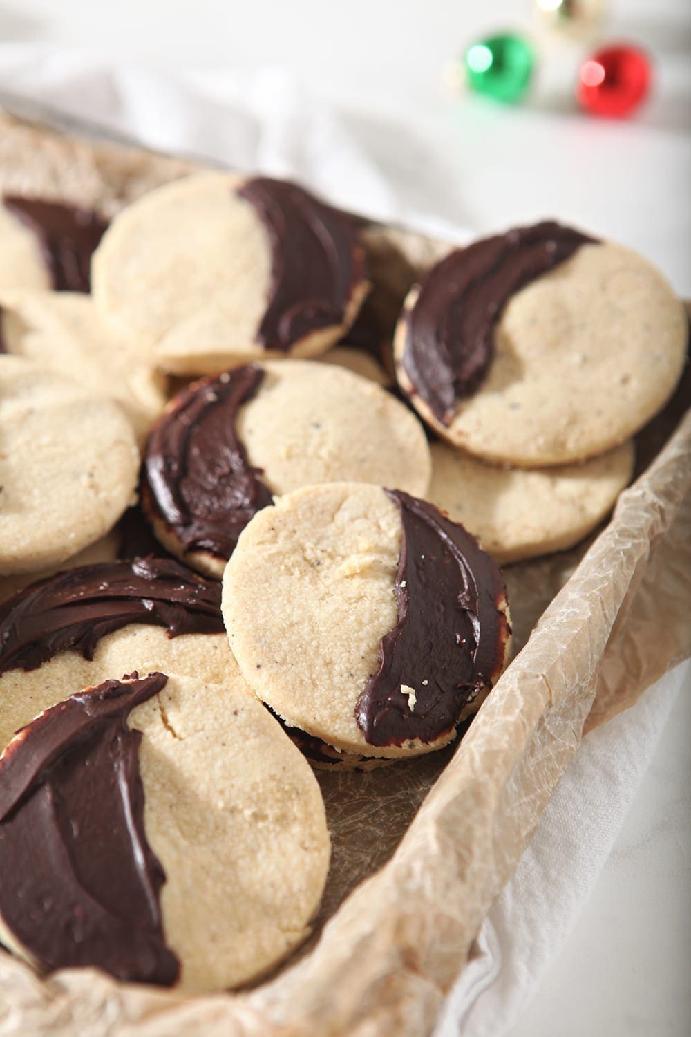 A tray full of Shortbread Brown Butter Cookies with ganache covering half of the cookies