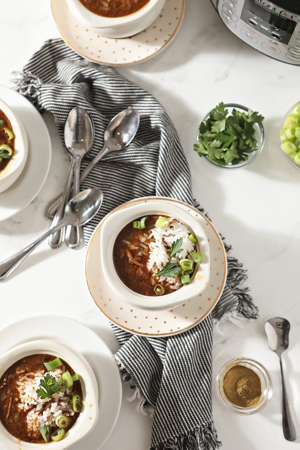 Small bowls of Instant Pot Gumbo, from above, garnished and ready to be eaten