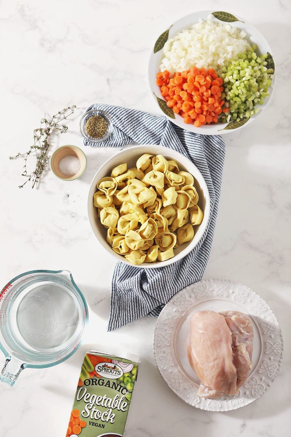 Ingredients for the slow cooker soup are laid out on a marble slab