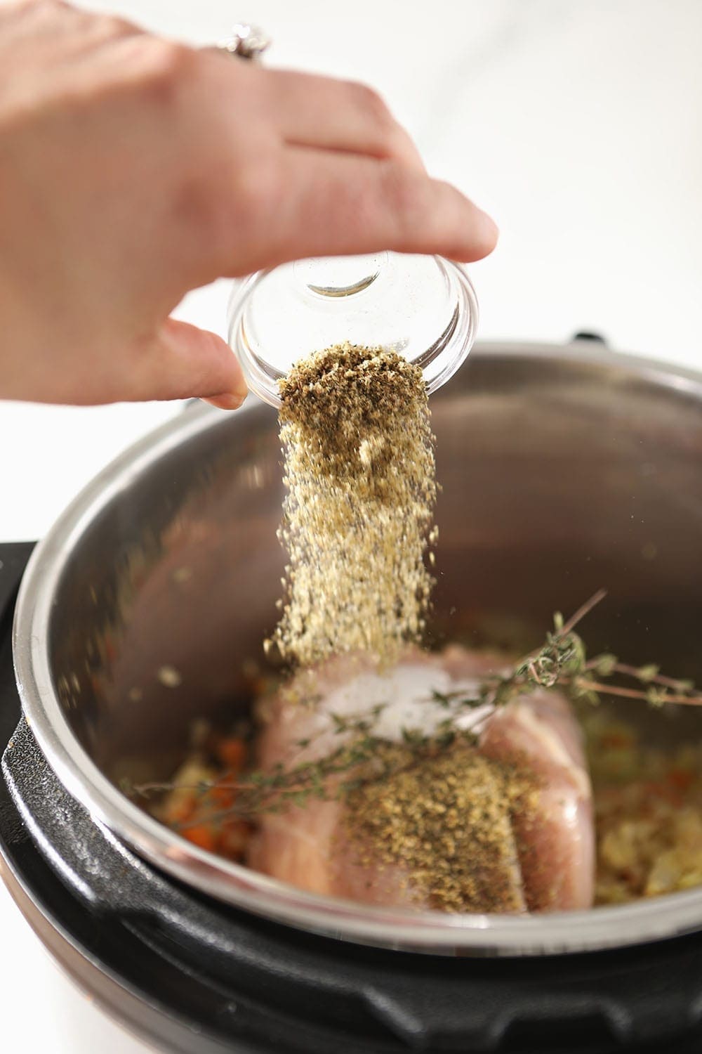 Mural of Flavor is poured on top of chicken and ingredients in the Instant Pot