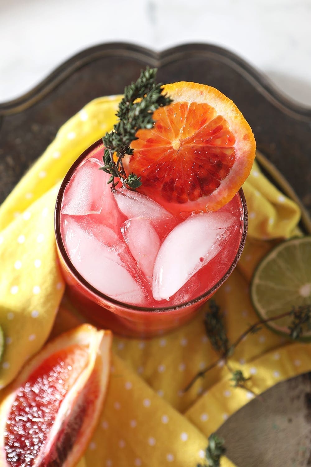 Close up of a Blood Orange Mocktail Mule from above, garnished with fresh thyme and a round of orange