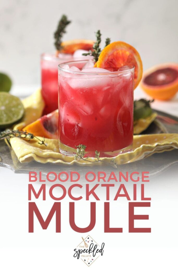 Close up of two Blood Orange Mocktail Mules on a platter, with Pinterest text