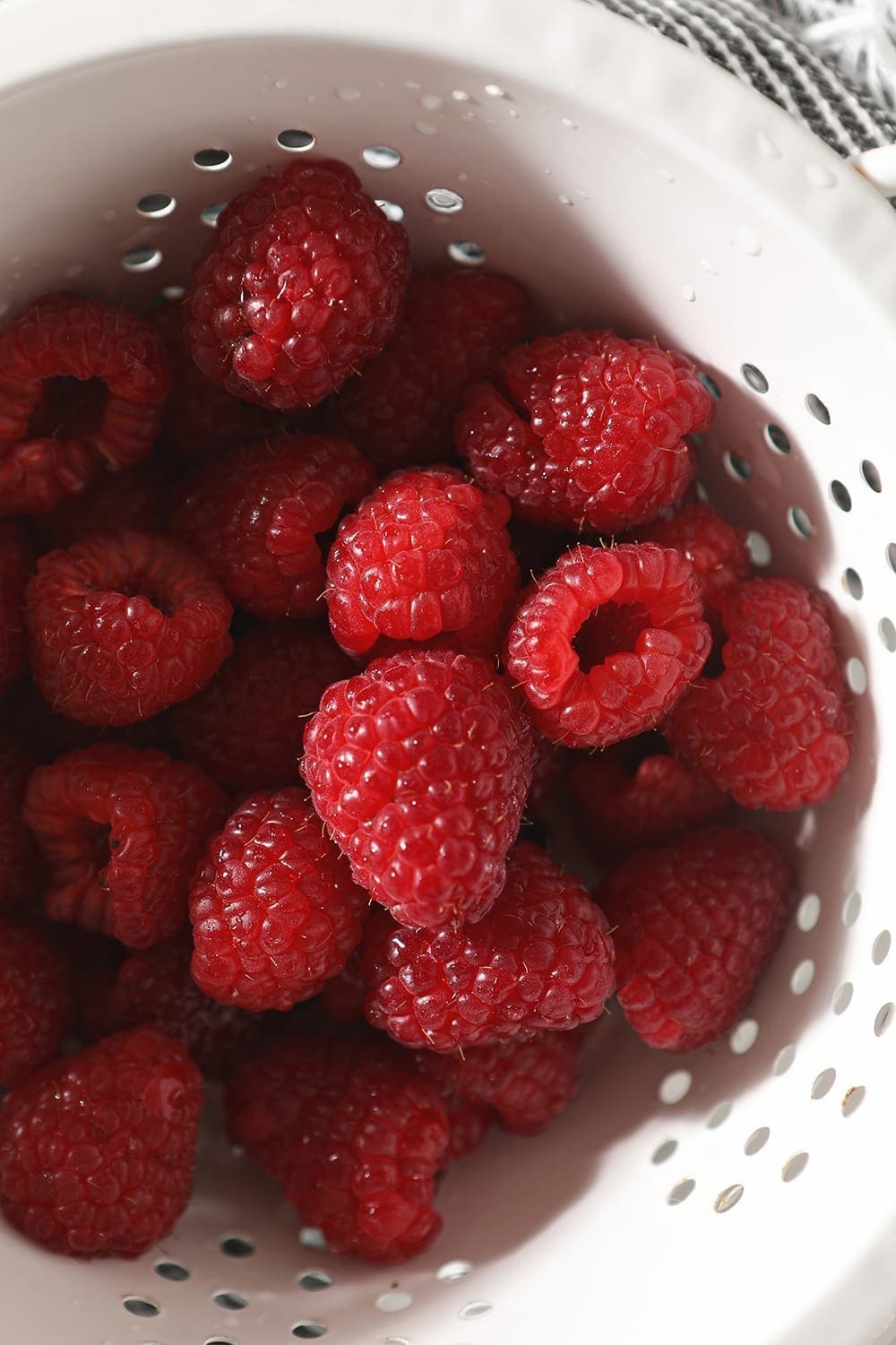 Raspberries in a white collander, from above