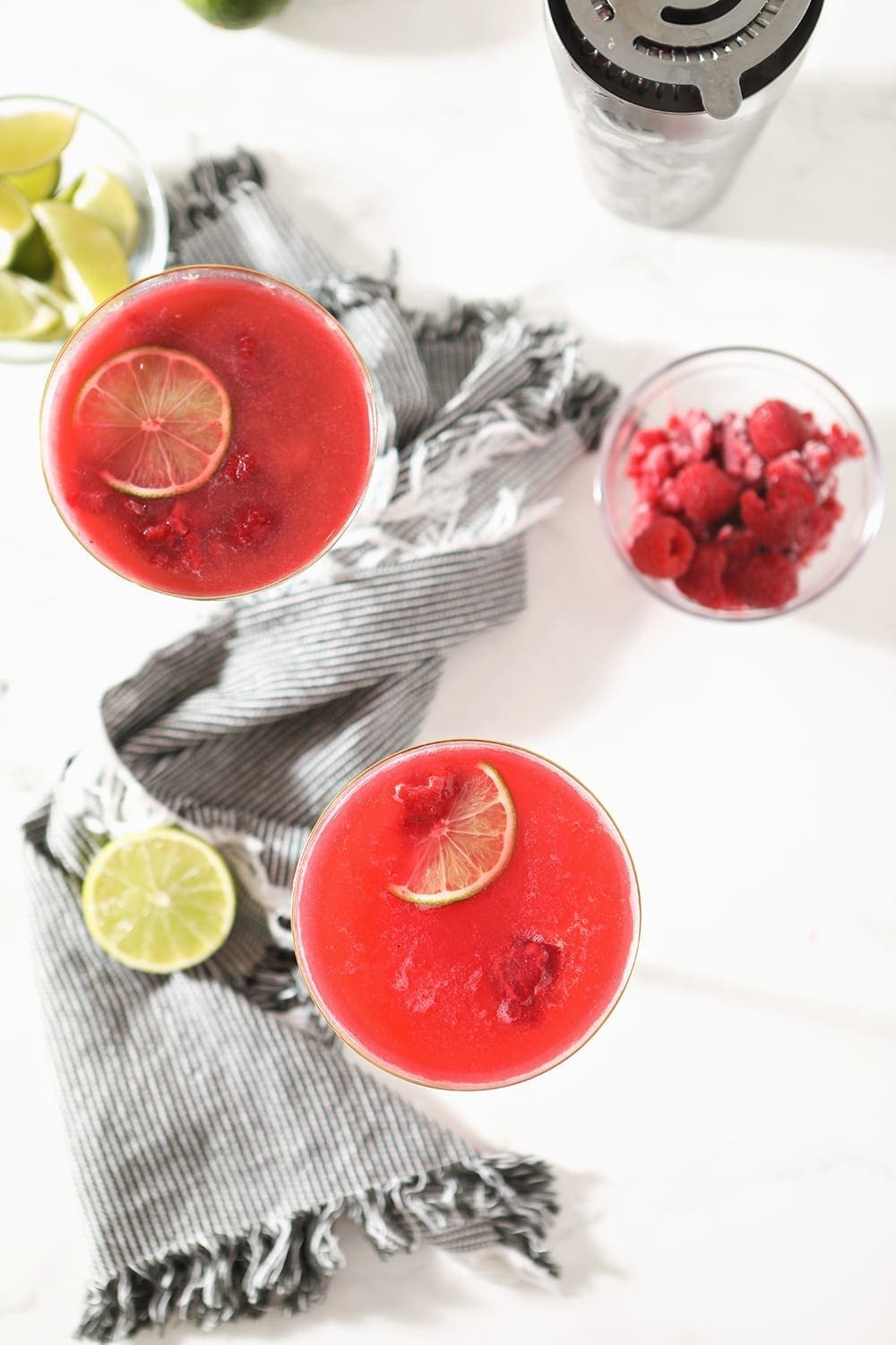 Overhead image of two glasses of Raspberry Mules, surrounded by ingredients