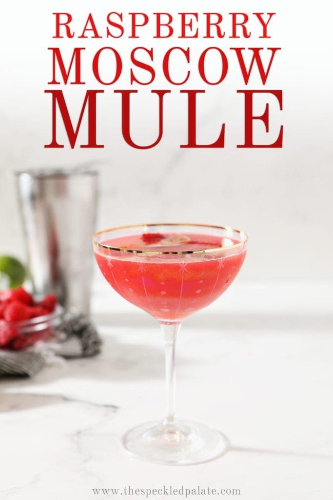 A single Raspberry Moscow Mule in a coupe glass sits on a marble background, with Pinterest text