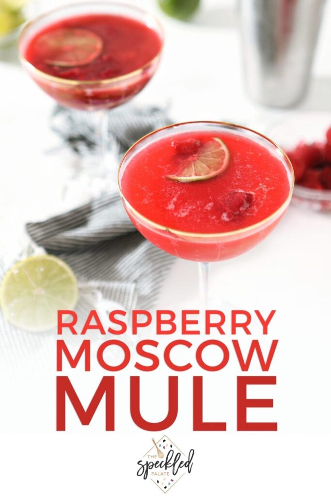 Two pink drinks, garnished with limes and raspberries with the text Raspberry Moscow Mule