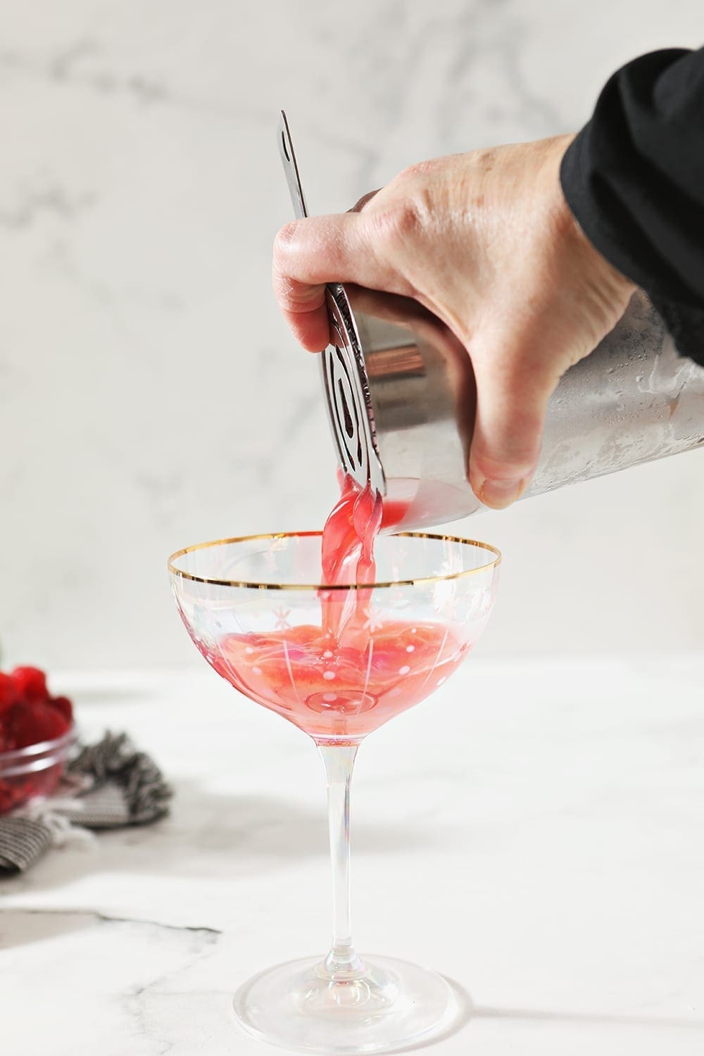 A Raspberry Moscow Mule is poured into a clear glass