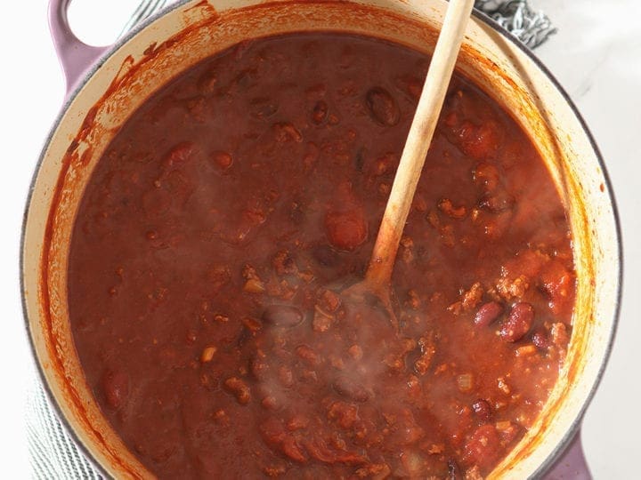 A Dutch oven is shown from above holding a ton of Shiner Bock Beer Chili