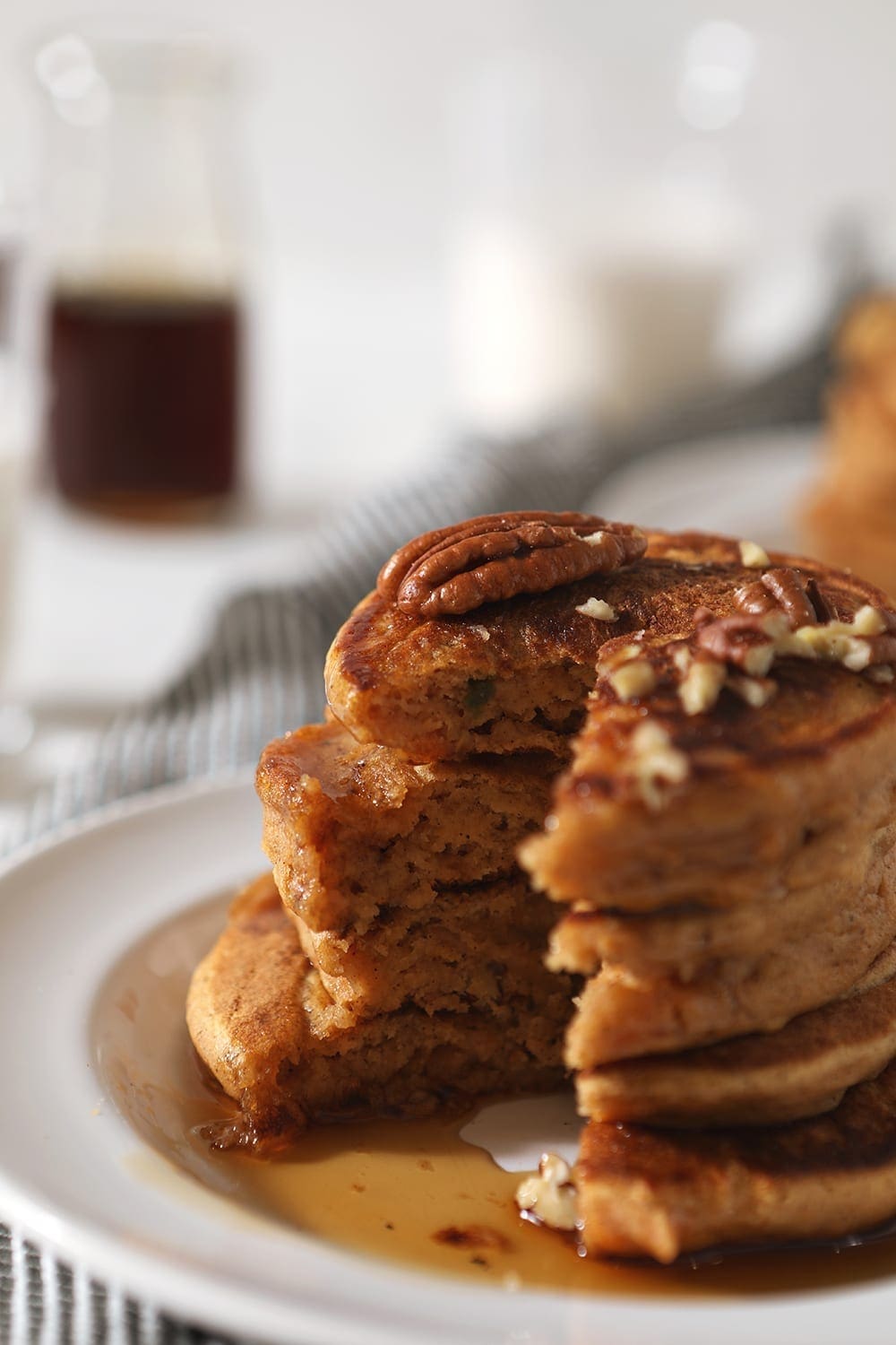 A close up of a stack of pancakes with a giant bite taken out of them