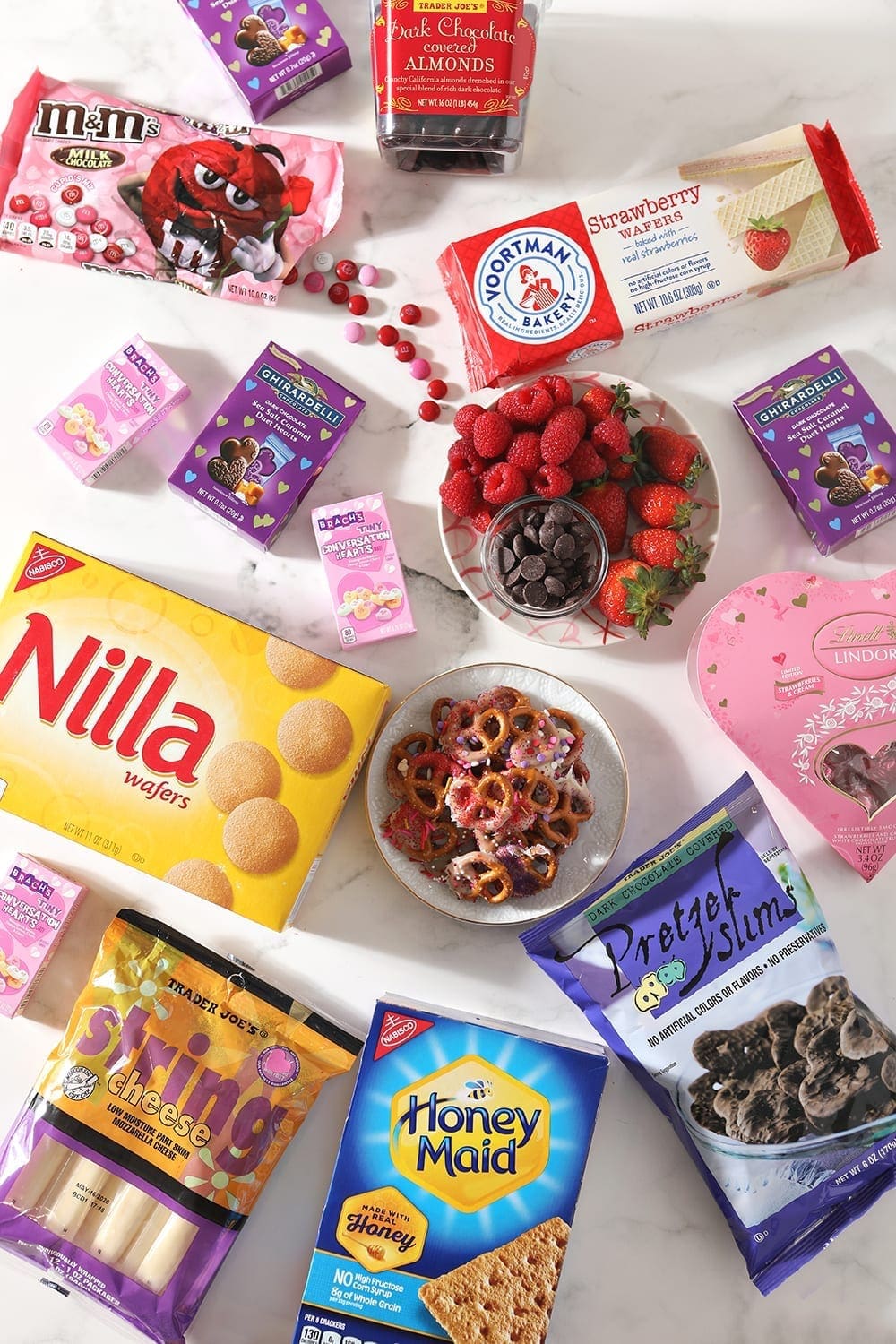 Ingredients to make a pink, purple and white dessert board