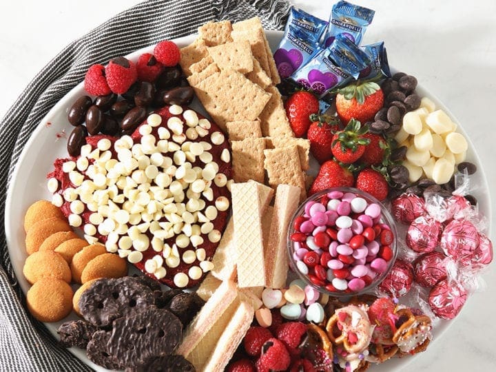 Overhead image of a white platter holding the Dessert Board, sitting on a blue striped napkin
