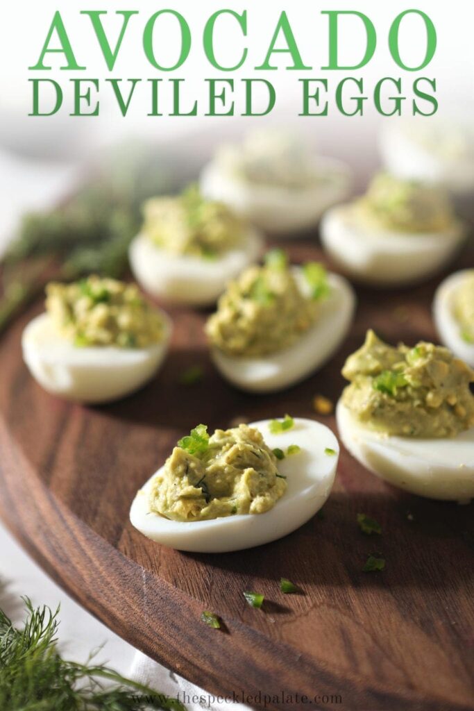 Avocado Deviled Eggs on a wood platter, with Pinterest text