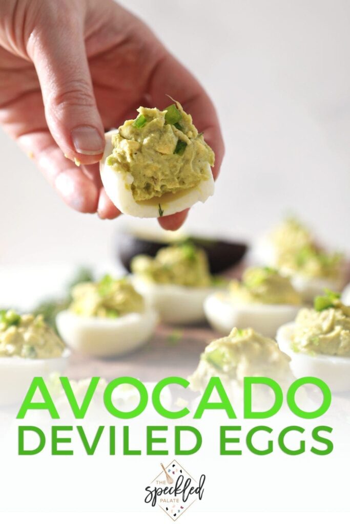 A woman holds a half-eaten Avocado Deviled Egg, with Pinterest text