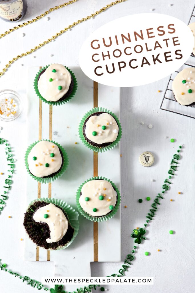 Overhead of several cupcakes decorated for St. Patrick's Day, with Pinterest text