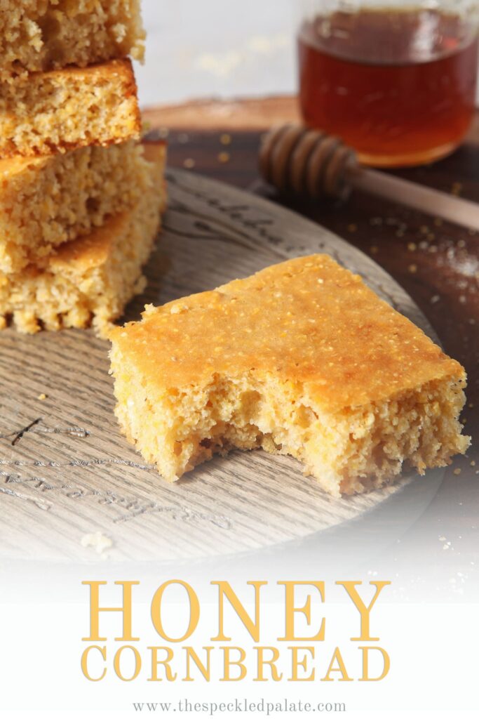 A piece of Honey Cornbread, with other slices, has a bite taken out of it, with Pinterest text