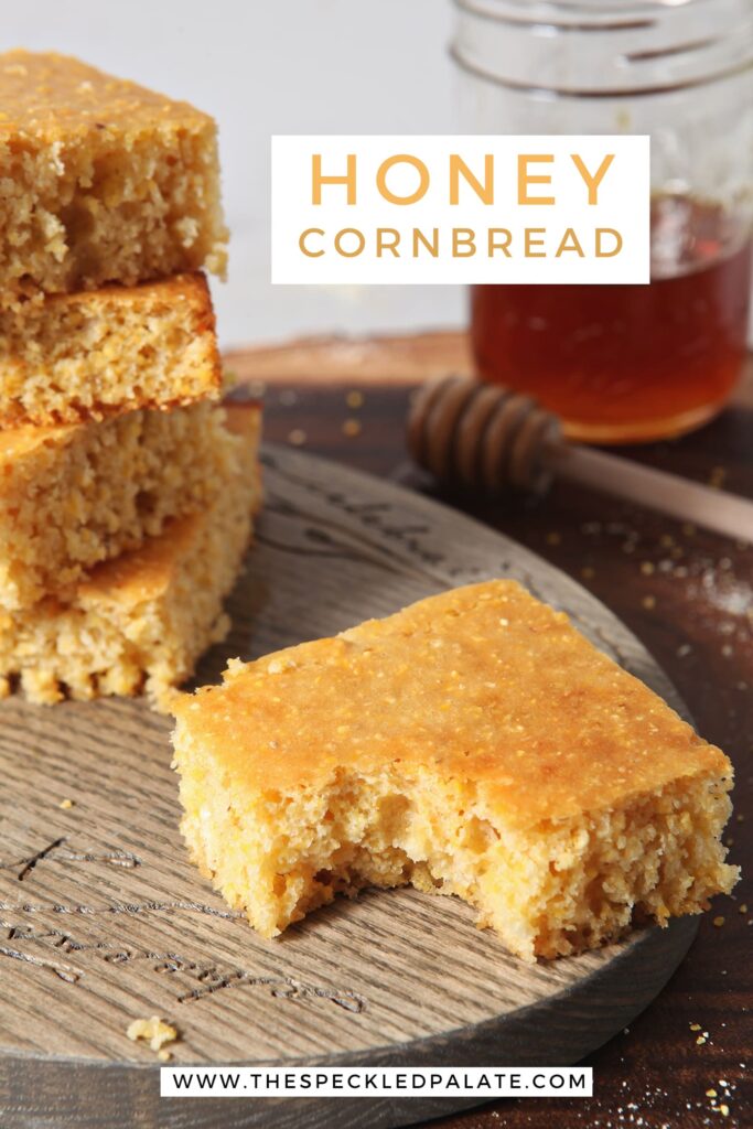 A piece of Honey Cornbread, with other slices, has a bite taken out of it, with Pinterest text