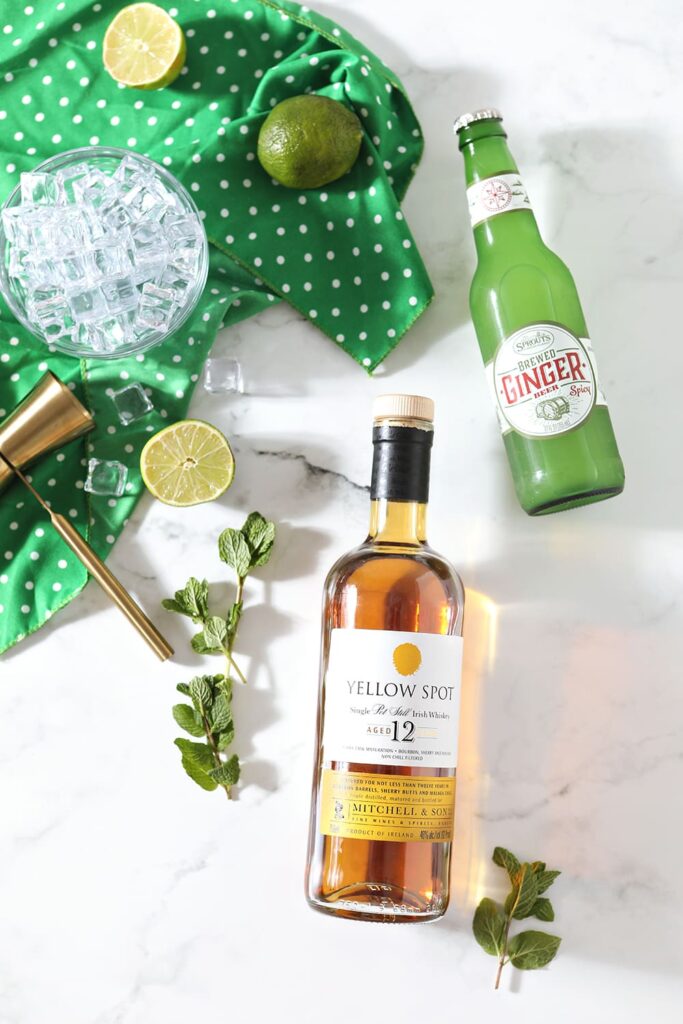 Ingredients for an Irish Mule are shown on a marble countertop, before mixing