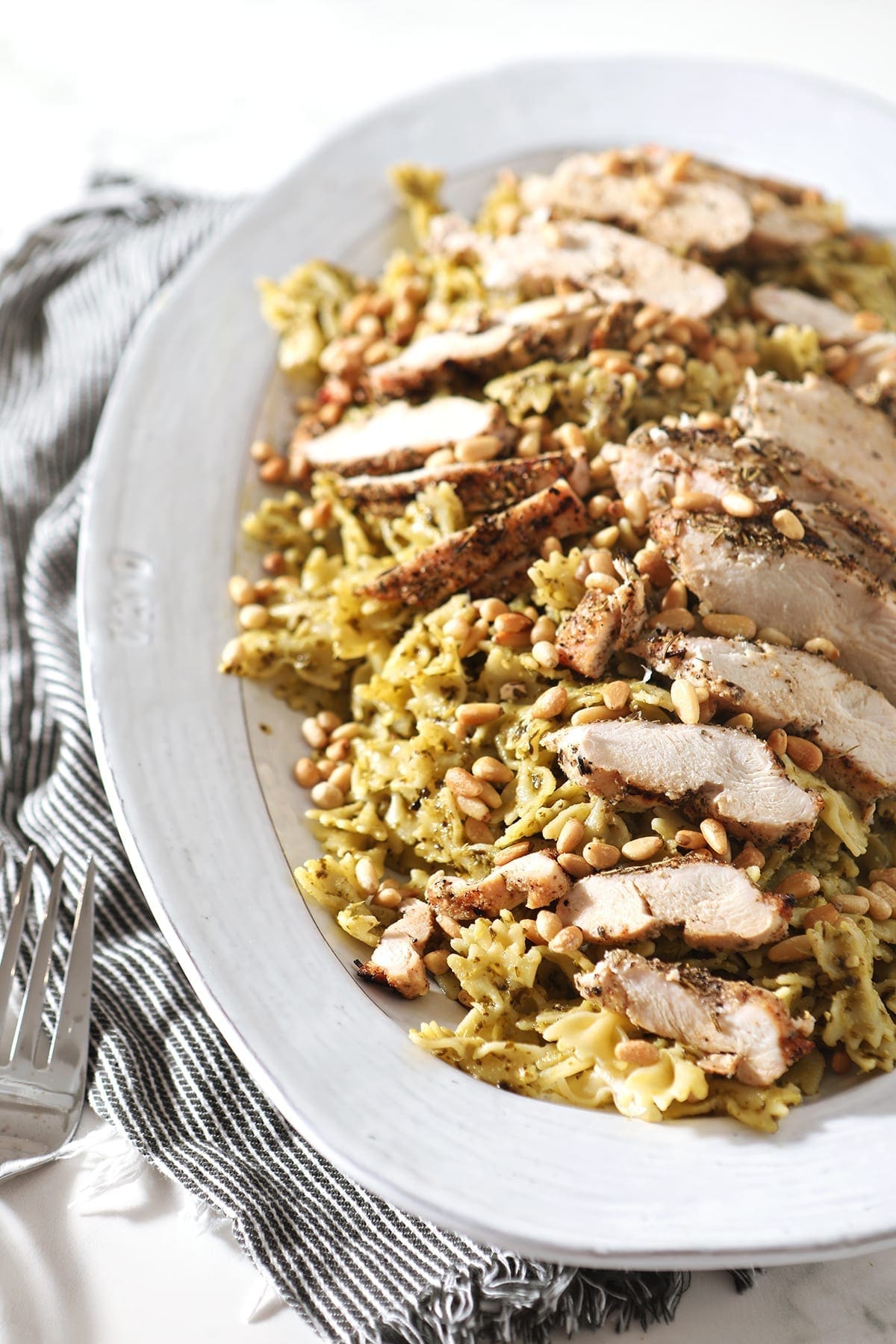 A platter holds the Chicken Pesto Pasta, before serving