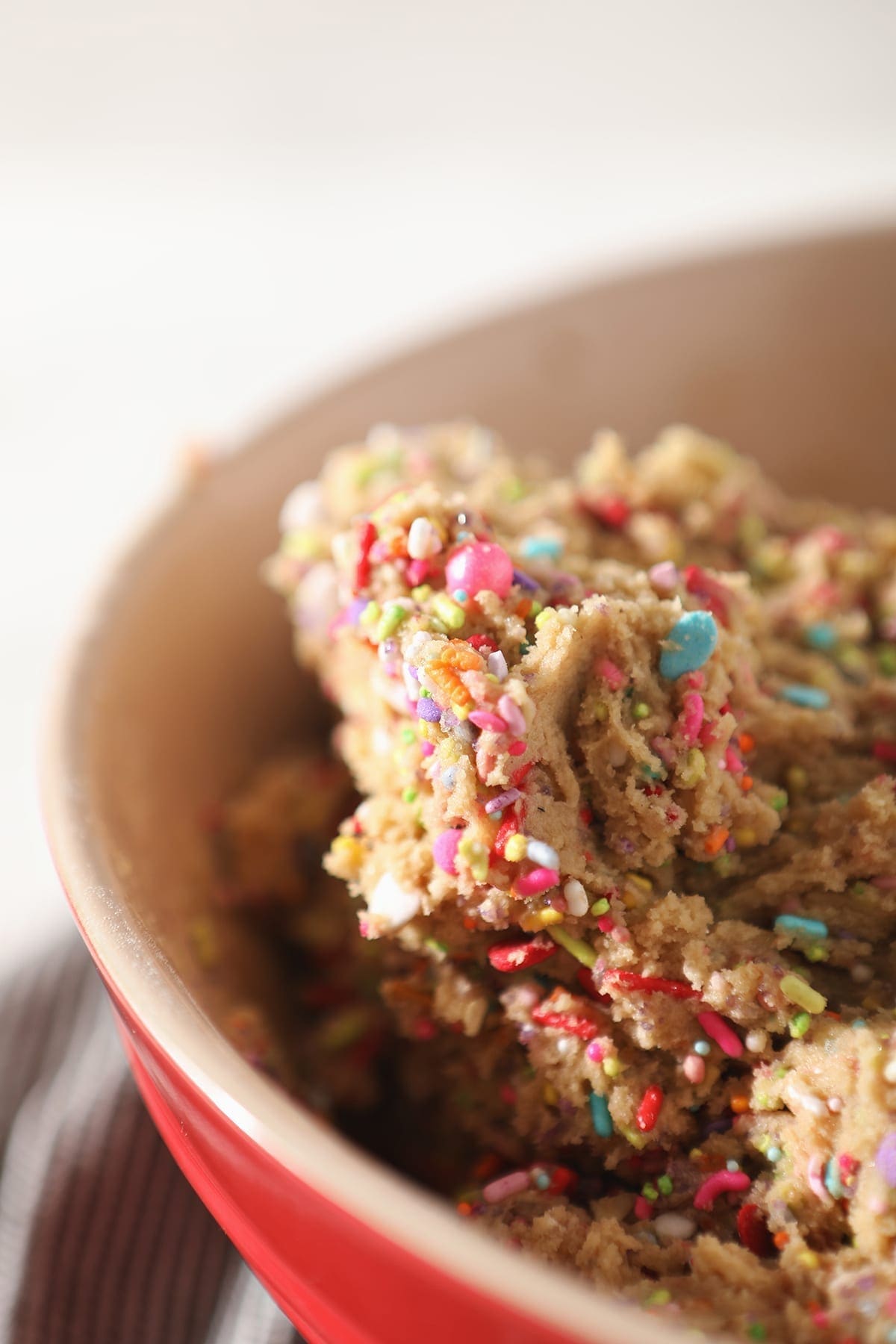 A close up of cookie dough with sprinkles