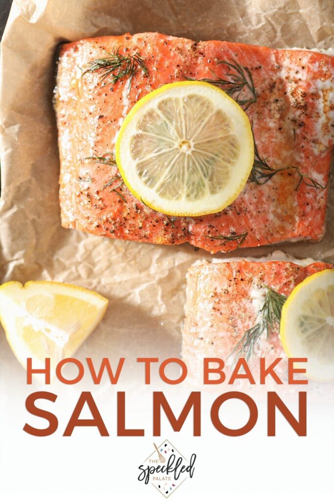 Close up of baked salmon garnished with lemon rounds on parchment paper with Pinterest text stating, "How to Bake Salmon"