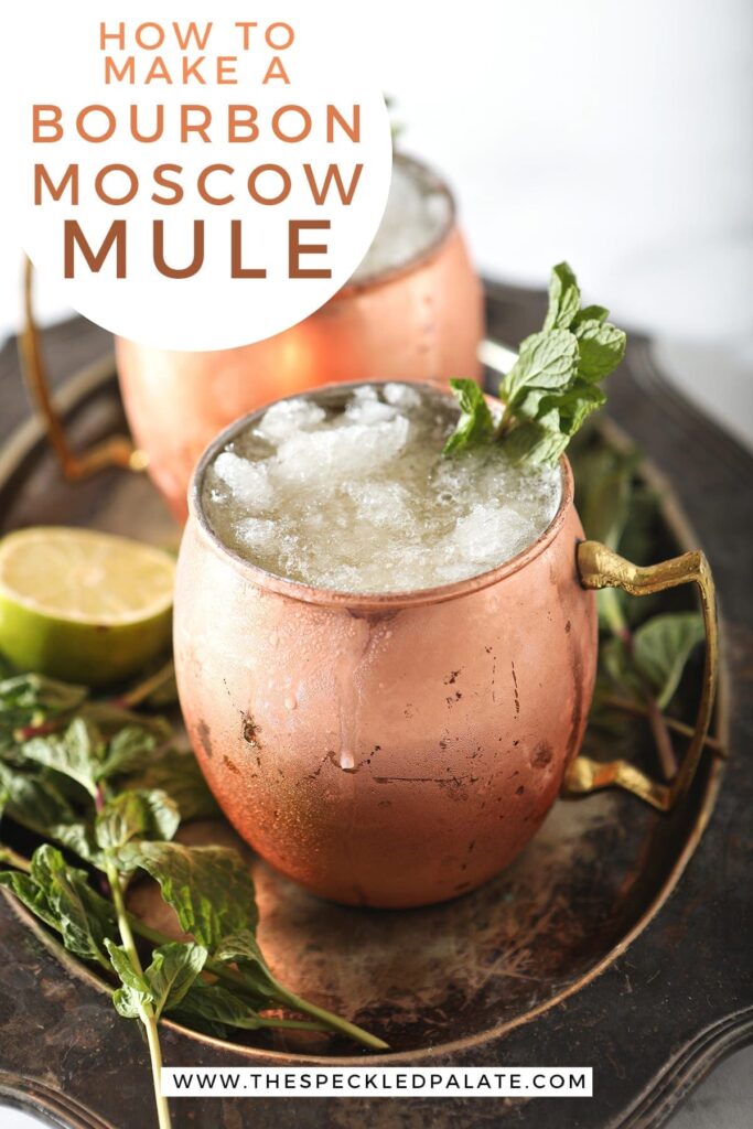 A silver platter holds two copper mugs holding Kentucky Bourbon Mules, with Pinterest text