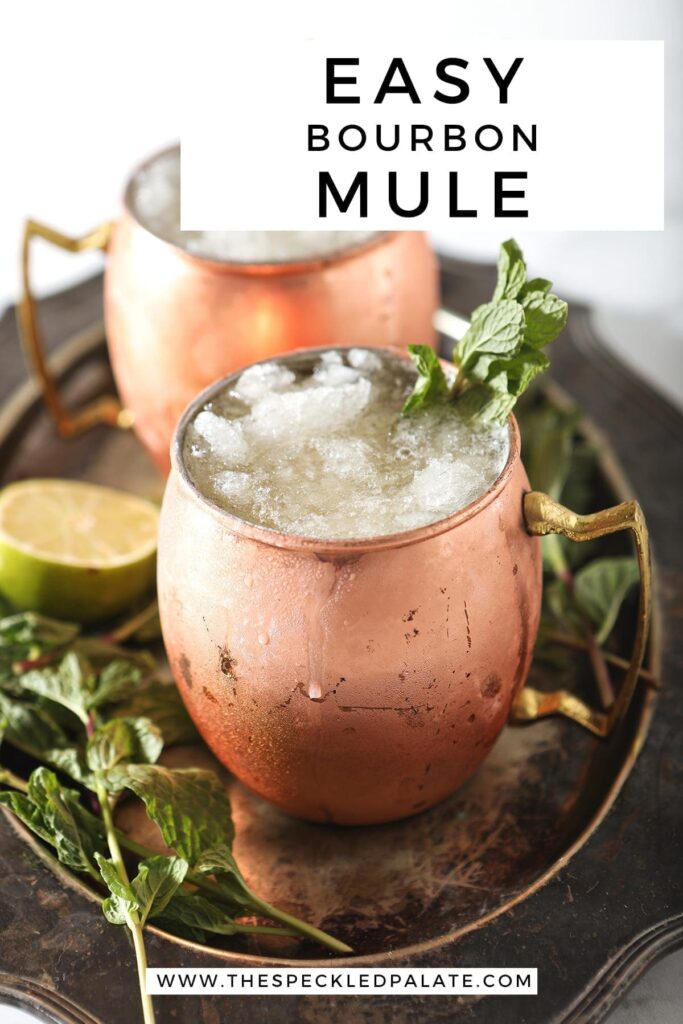 A silver platter holds two copper mugs holding Kentucky Bourbon Mules, with Pinterest text