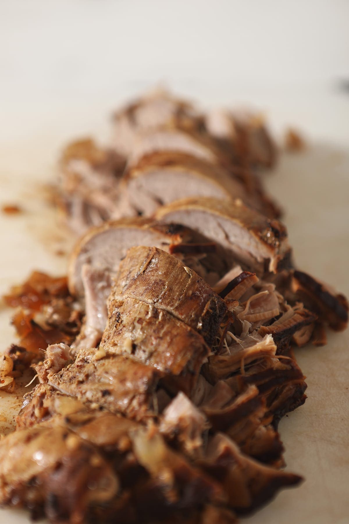 Chopped pork tenderloin on a white cutting board