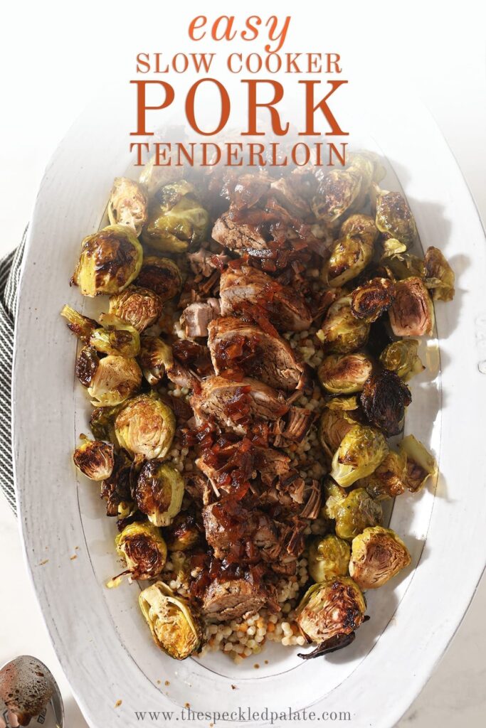 Sliced pork tenderloin and brussels sprouts on a large white platter, with text that says 'Easy Slow Cooker Pork Tenderloin'