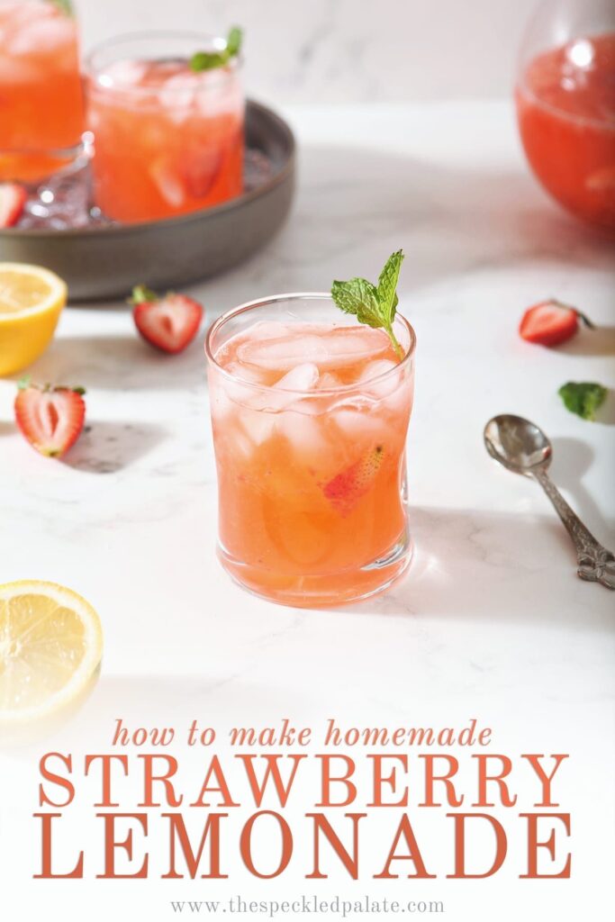 A glass of Strawberry Lemonade is shown with fresh strawberries and lemon slices with text at the bottom