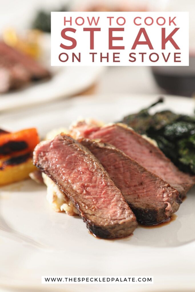 Close up of three slices of cast iron ribeye on a white plate with other sides with text stating "how to cook steak on the stovetop"