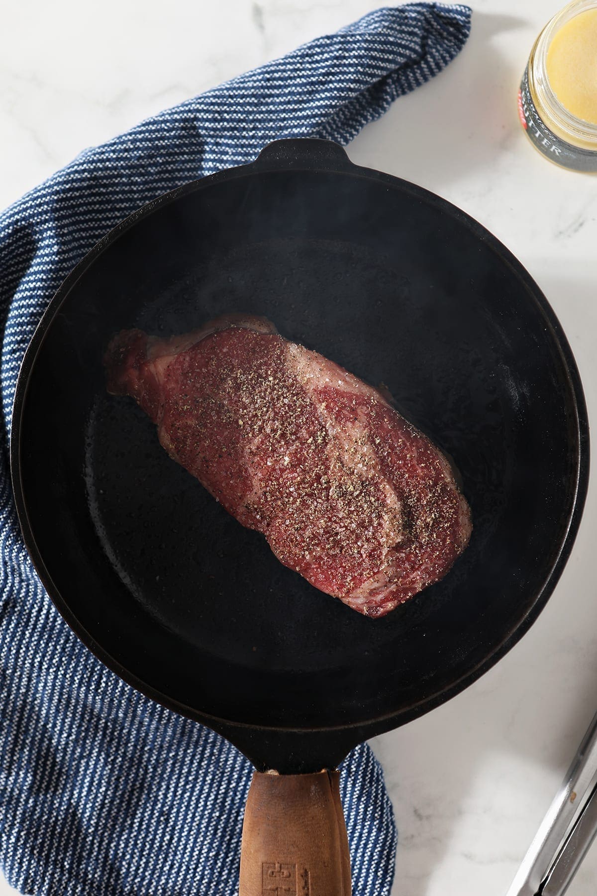 A ribeye in a cast iron skillet, from above