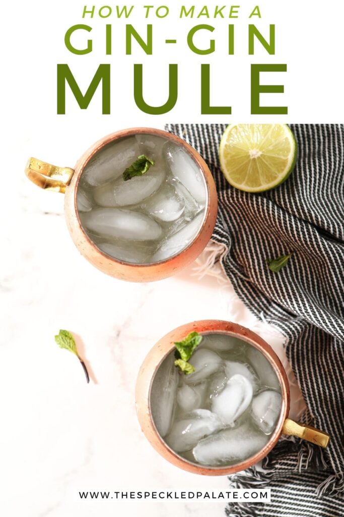 Two Gin Gin Mules in copper mugs on a marble surface sit next to a blue striped towel, lime rounds and mint leaves, with text stating "How to Make a Gin-Gin Mule"