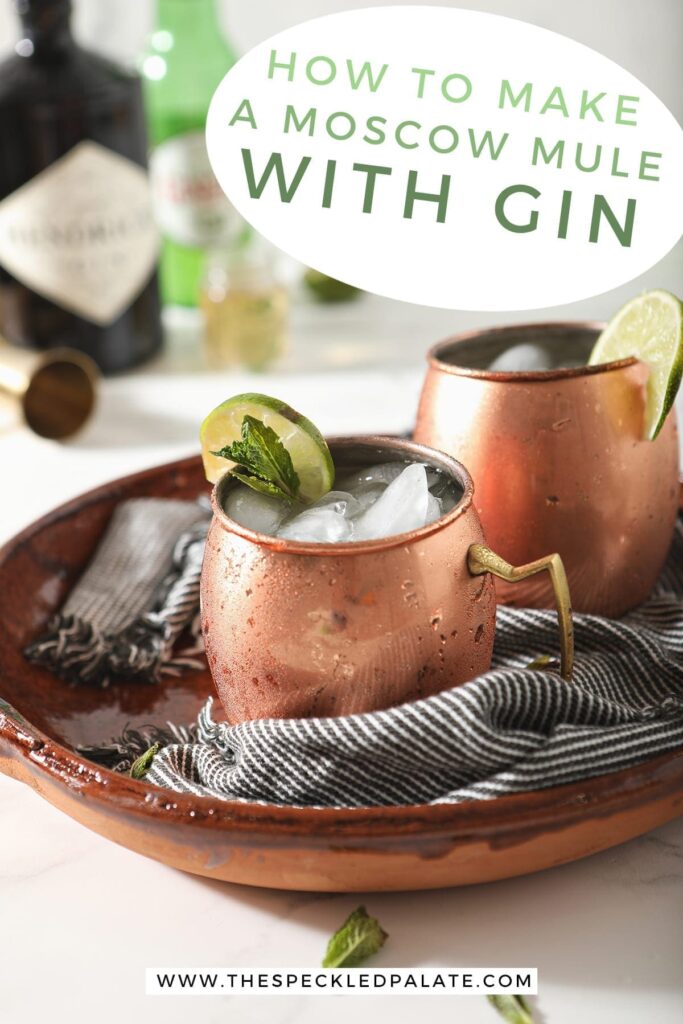 Two copper mugs garnished with lime rounds and mint are shown in a brown serving tray holding Gin Gin Mules, with text stating "How to Make a Moscow Mule with Gin"